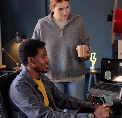 man and a woman observing a computer screen
